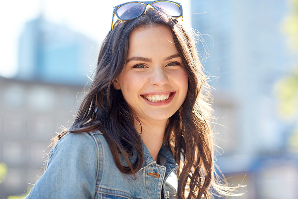 Smiling woman with sunglasses on her head